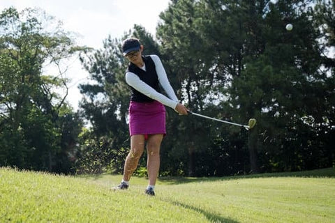 female golfer hitting a chip shot using the "Y" angle