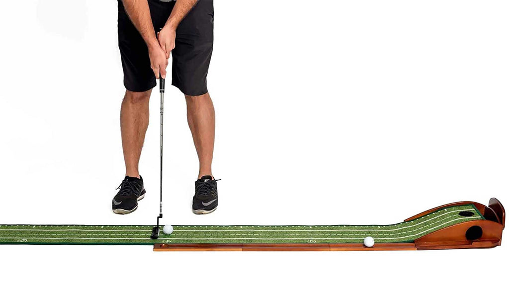 man putting on a perfect practice putting mat