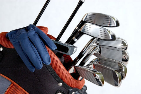 Golf clubs and glove in an organized golf bag.