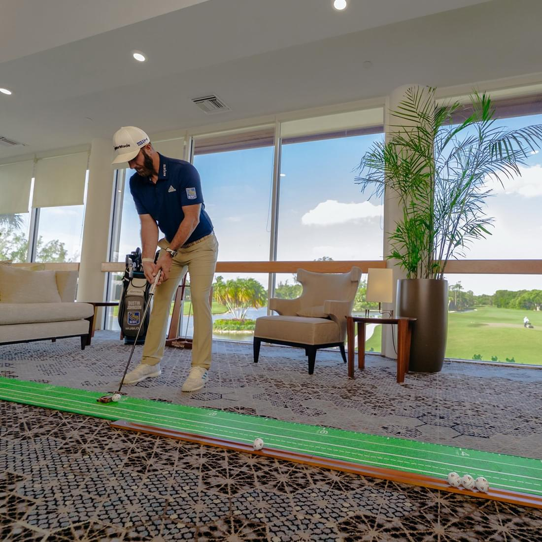 A man uses the indoor hitting mat, the Perfect Putitng Mat V4 XL Edition.