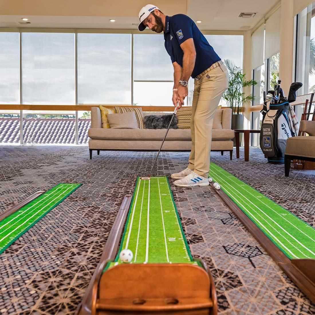 A man lines up a shot on the Perfect Putting Mat V4 Standard Edition indoor golf simulator.