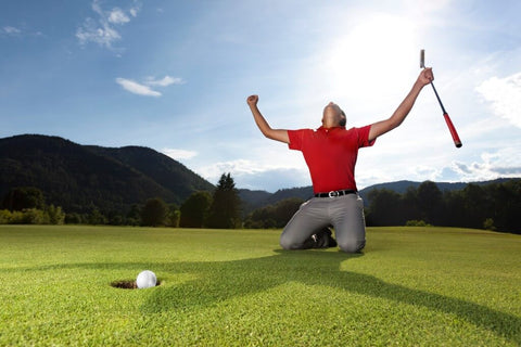 Man celebrating making a putt on the golf course 