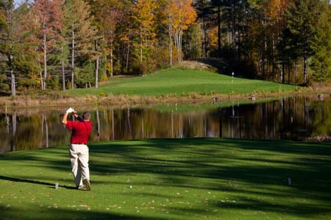 golfer teeing off