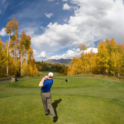 righty golfer hitting tee shot during round of golf in the fall