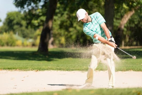 golfer wide stance in sand trap