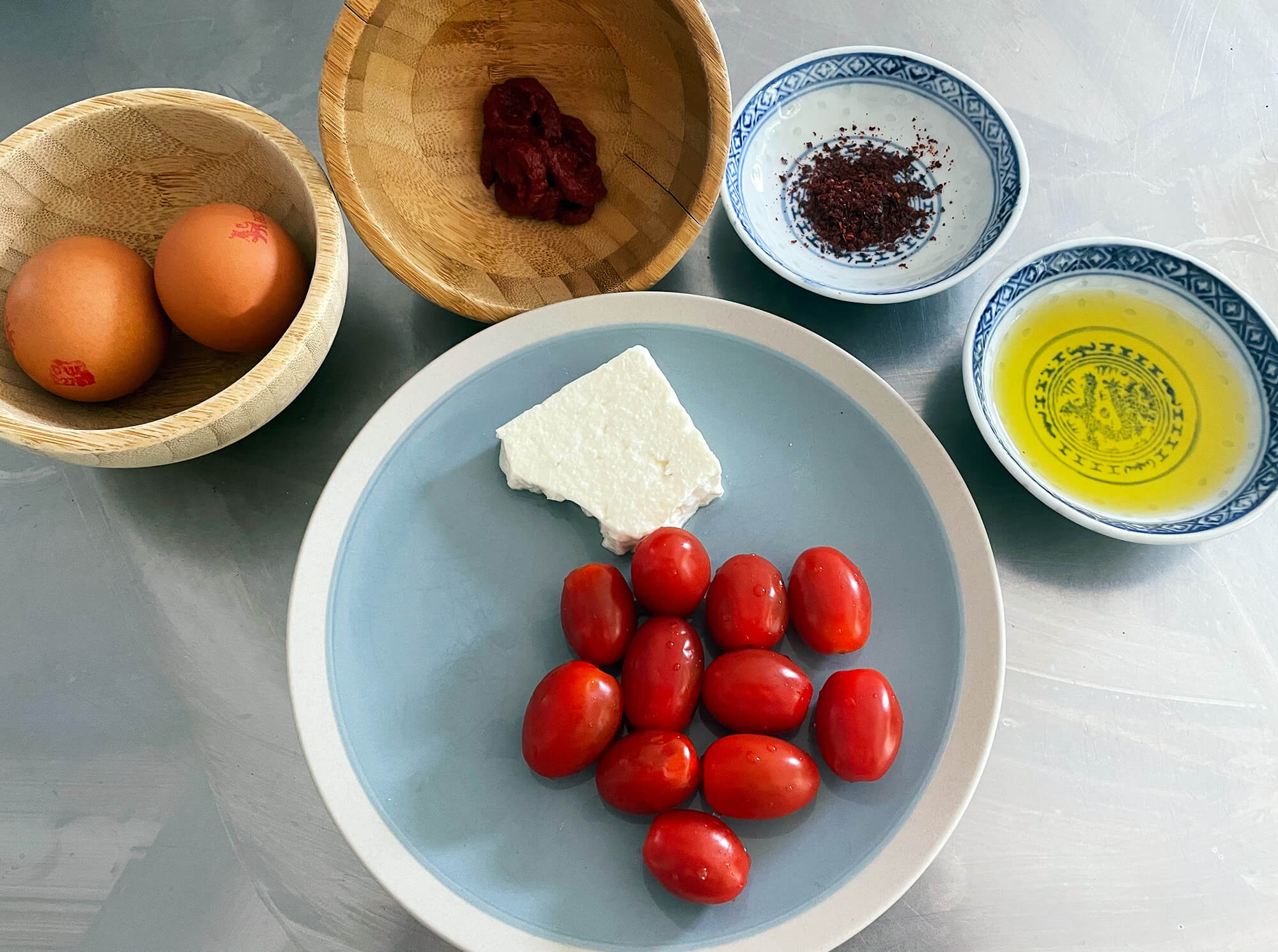 greek tomatoes, feta cheese, eggs, olive oil, tomato paste and chilli flakes, ingredients for the Greek dish of kagianas
