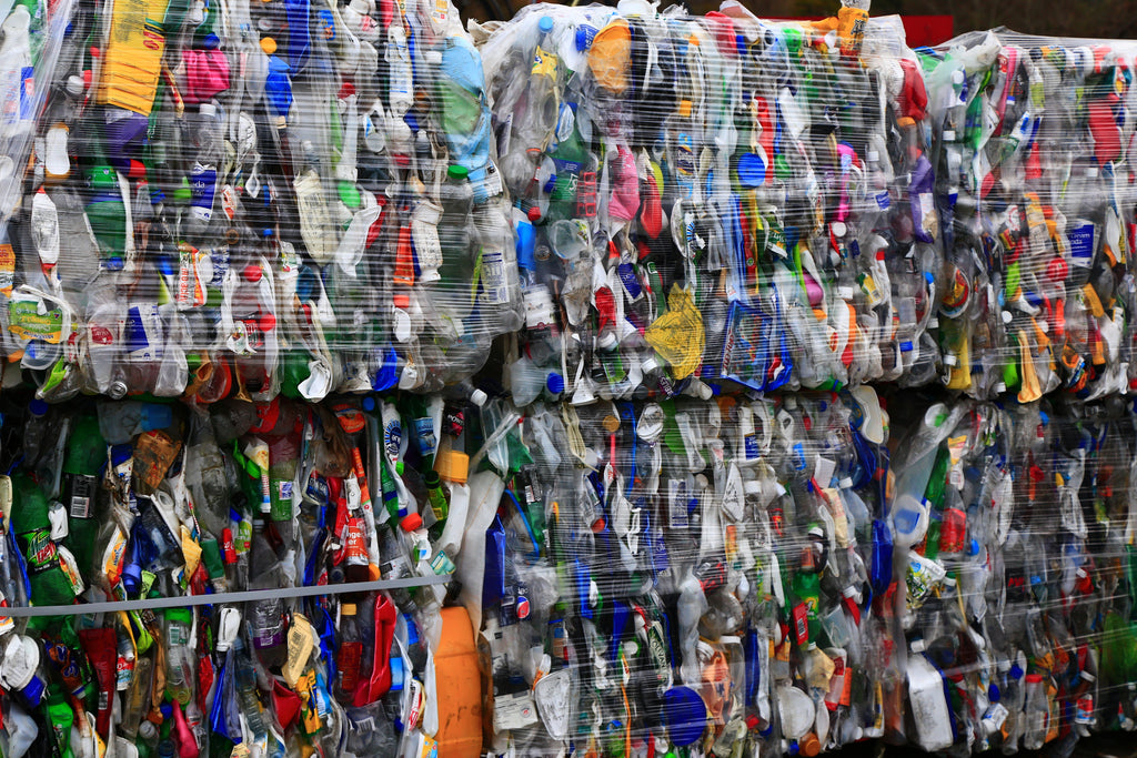 Plastic containers baled up at a MRF waiting for shipment elsewhere to be recycled.