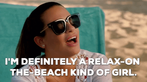 gif of Leah Michelle on a beach wearing sunglasses saying "I'm definitely a relax-on-the-beach kind of girl"