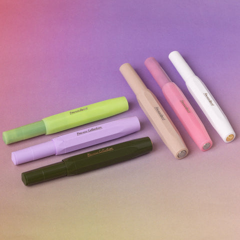 Colorful fountain pens on a purple gradient background