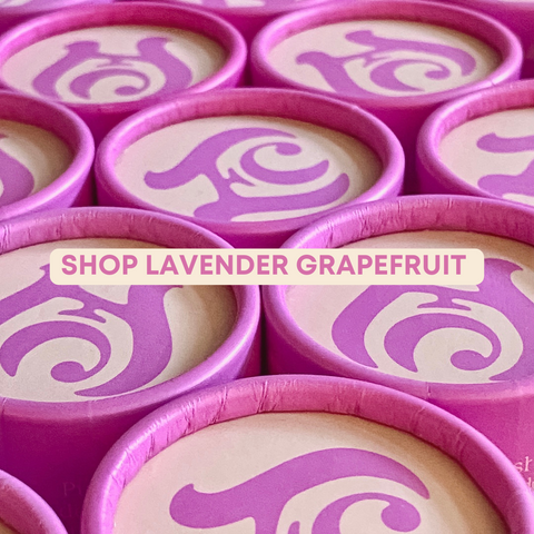 Pink tops of deodorant tubes that have the Eco Collective logo