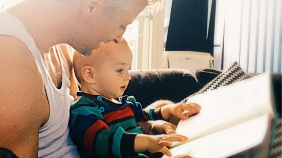 Man reading with baby