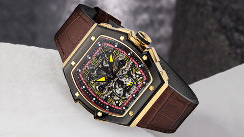 This is a brown leather watch with a mixture of black and gold face. It is a skeleton see through watch with automatic movements.
