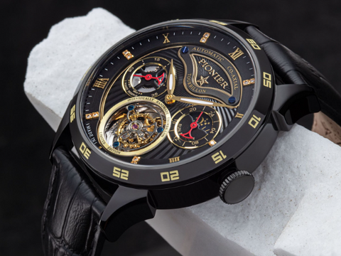 Geneva Tourbillon from Tufina. This is a German black tourbillon watch. It is made of stainless steel and it comes with a black leather band. It is an open heart watch with diamonds and two sub-dials.