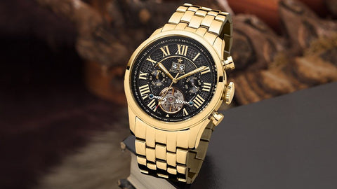 Tufina Pionier Havana Automatic Full Calendar Watch For Men with a gold case, black dial, gold Roman numerals, date calendar window, gold metal bracelet