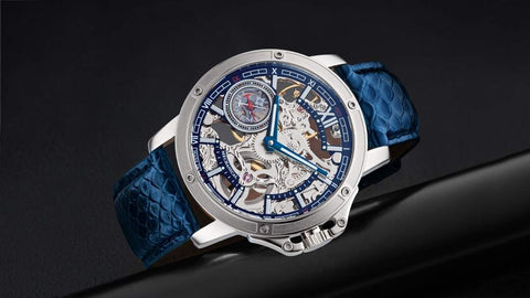 This is Tufina's Lagos GM-113-2 watch from the Theorema collection, a skeleton dial watch with a mechanical movement, open front and back composition, blue leather band with fish skin pattern and luminous hands.