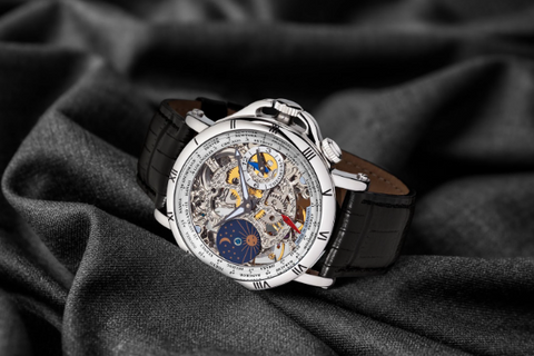 Sao Paulo from Tufina is a skeleton watch for men with a sun and moon phase compilation. It is a silver watch with a black leather band and world time function.