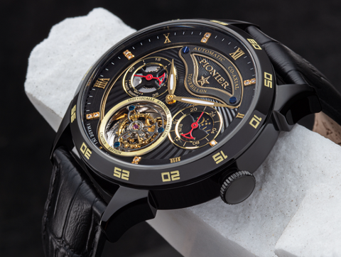 This is Geneva Tourbillon a mechanical watch for men. It has an in-house movement, a sapphire crystal, two sub dials and double colored hands. This open heart watch comes with a black dial and a black leather band.