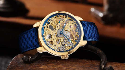 Tufina Theorema Venezia GM-118-4 skeleton watch for men with a mechanical movement, gold colored case, blue fish pattern leather band and s standard clasp