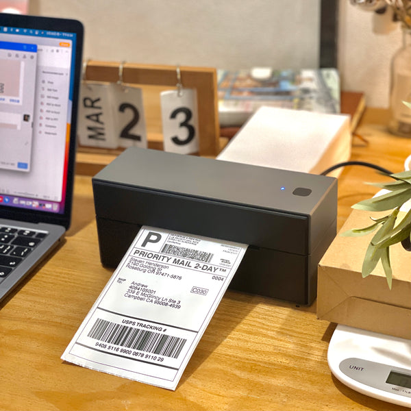 The black Bluetooth label printer ITPP129 is printing a shipping label.