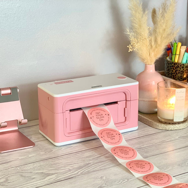 MUNBYN Bluetooth label printer is printing pink stickers.