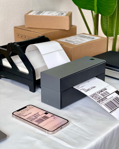 MUNBYN wireless label printer is printing shipping labels via Bluetooth.