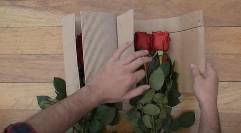 person unpacking red roses bouquets