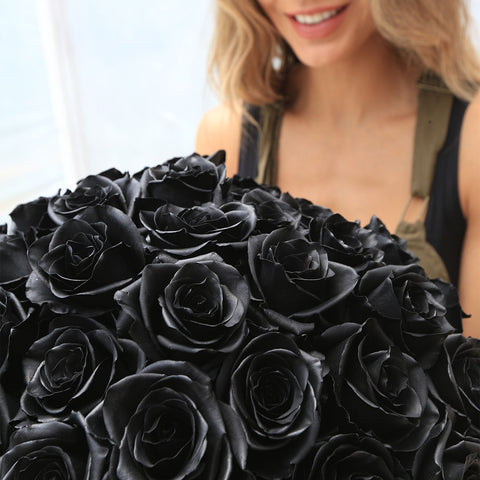 Girl smiling at the back with Rosaholics' Black Roses