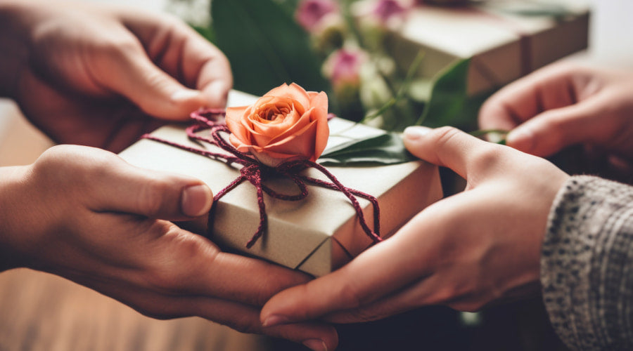 Handing over a gift with a single rose on top