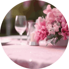 Table setting with pink flowers and clear wine glasses