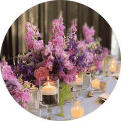 Lavender and pink floral centerpiece with candle votives