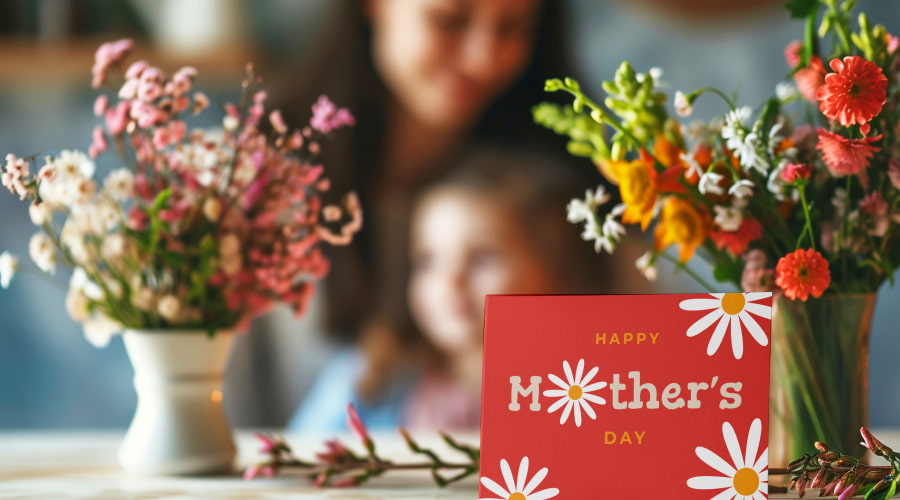 Blurry family behind a Mother’s Day card and flowers