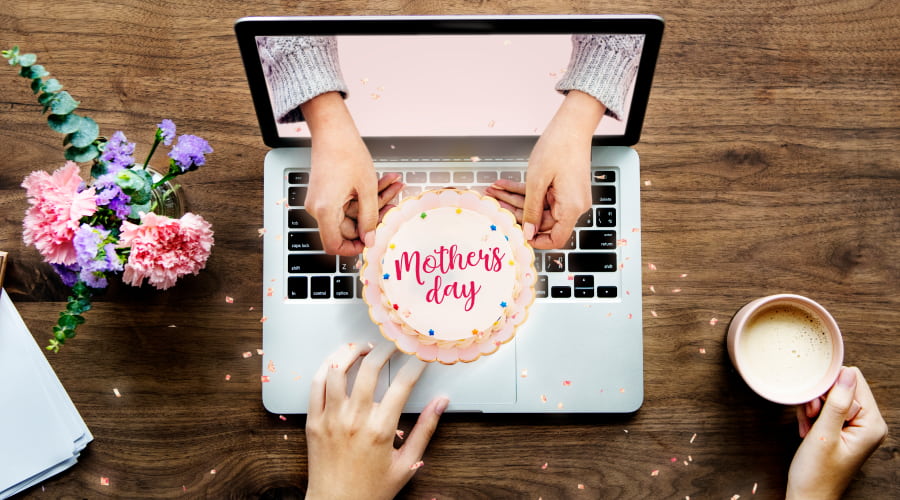 Laptop with Mother's Day cake and flowers