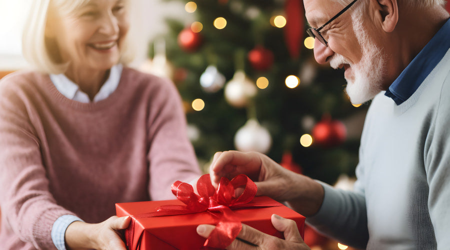 Elderly couple with a red gift box