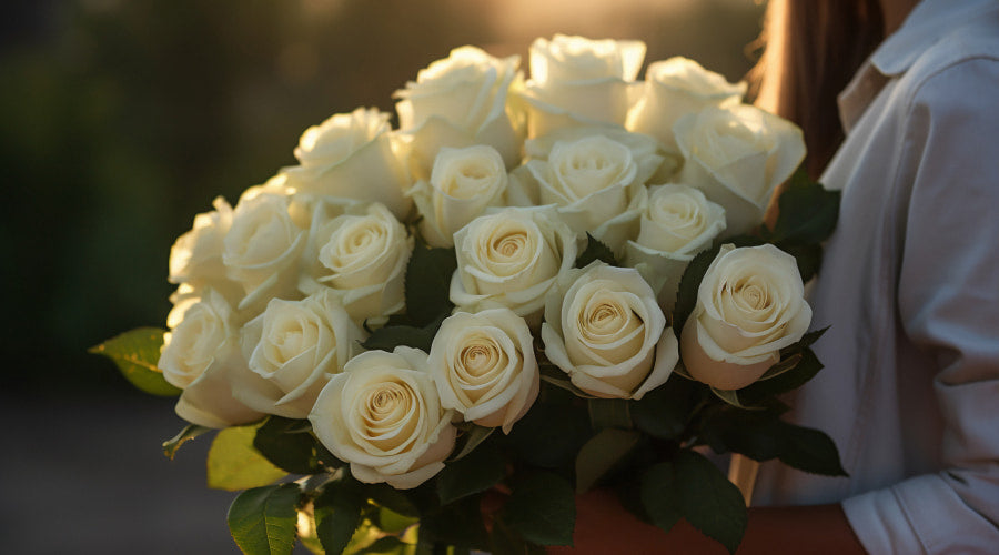 Woman holding a bouquet of white roses