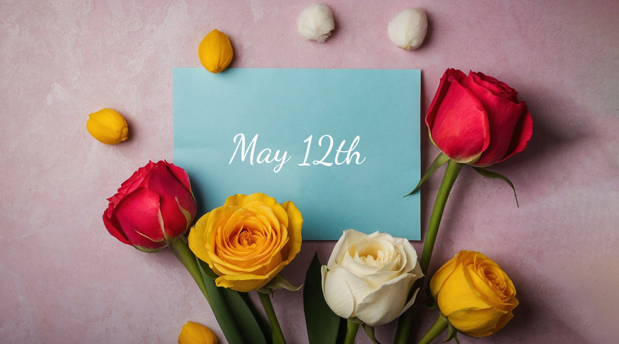 Pink background with red and yellow roses and a "May 12th" card