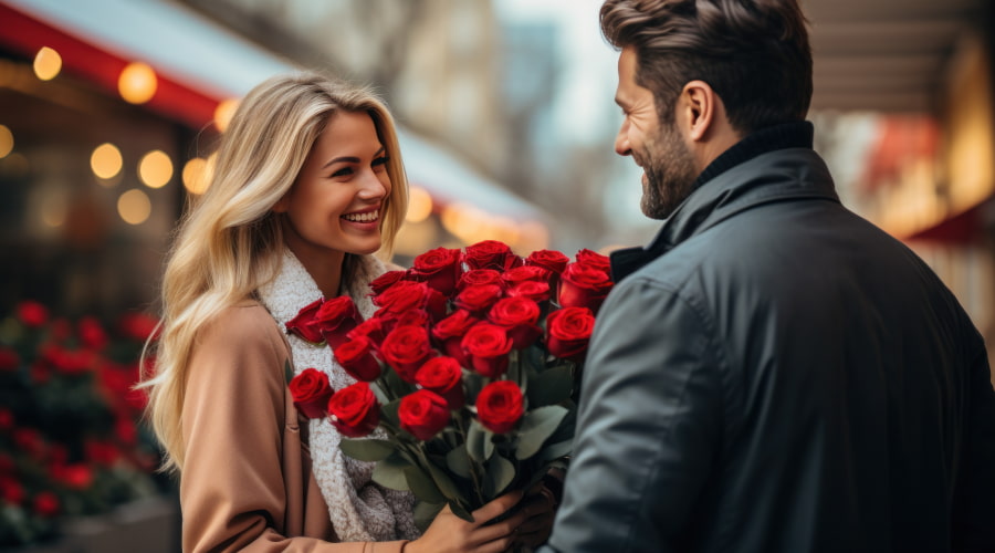 the guy gives the girl a bouquet of red roses