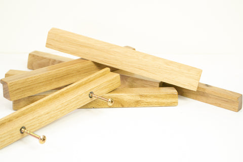 Small wood handles, oak drawer pulls showing snap off screw fittings