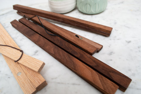 Walnut poster hanger strips showing the wood grain