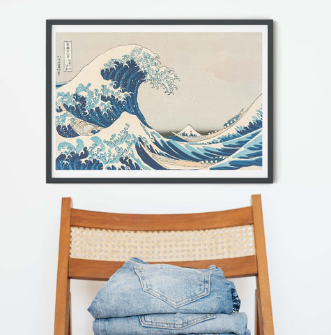 The Great Wave off Kanagawa by Katsushika Hokusai framed Japanese Art Prints on the wall with brown chair