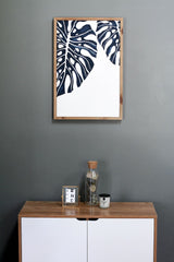 minimalist botanical print above a cupboard