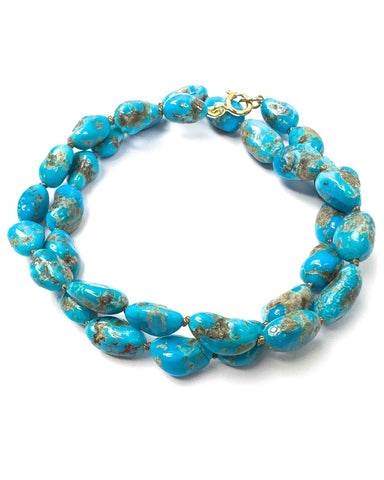 Small bright blue castle dome turquoise nuggets hand-knotted into a 17.25 inch necklace.