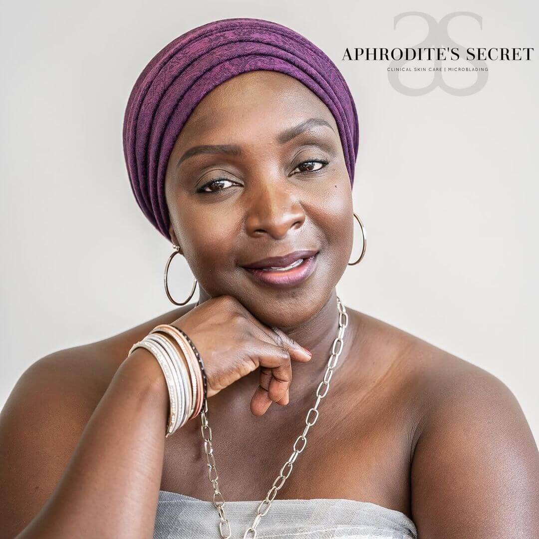 a black woman with beautiful and well-defined ombre powder brows, smiling