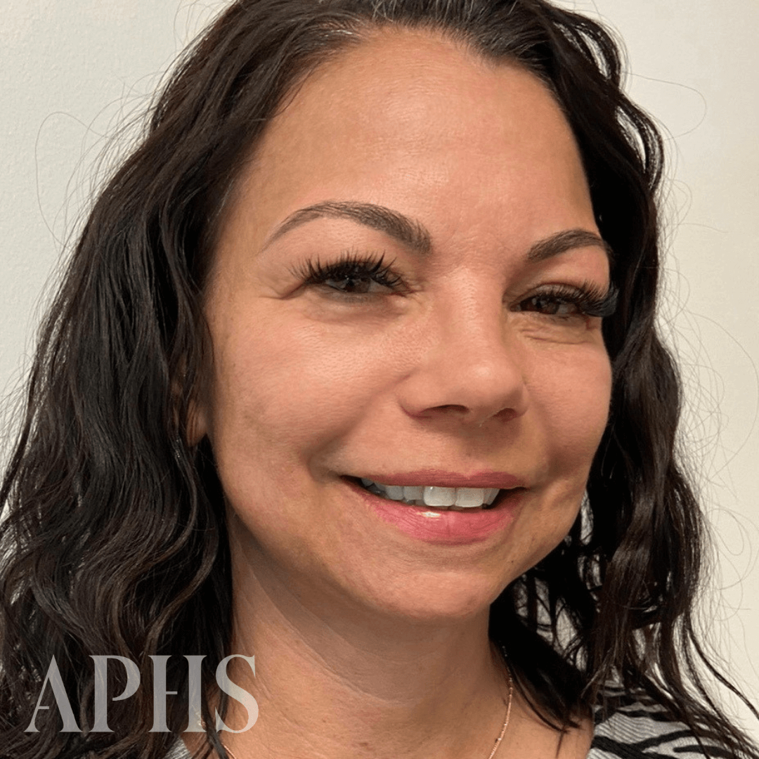 Woman smiling with full and semi-dark brows