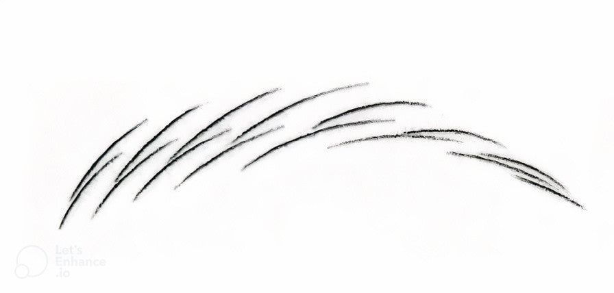 A drawn eyebrow shape using microblading strokes