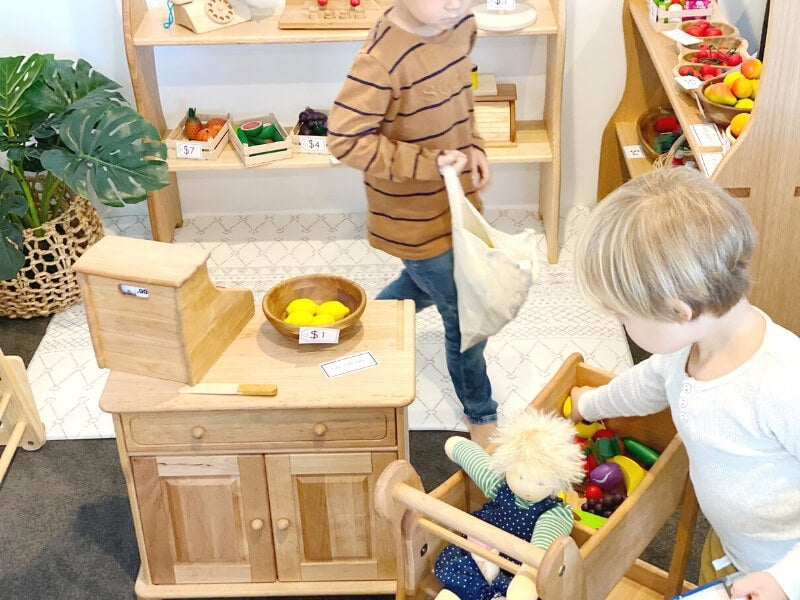 Playing shops with Drewart wooden shopping trolley