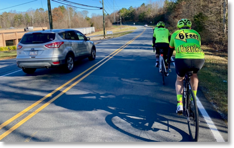 Car passing cyclists with more than 6 feet separation