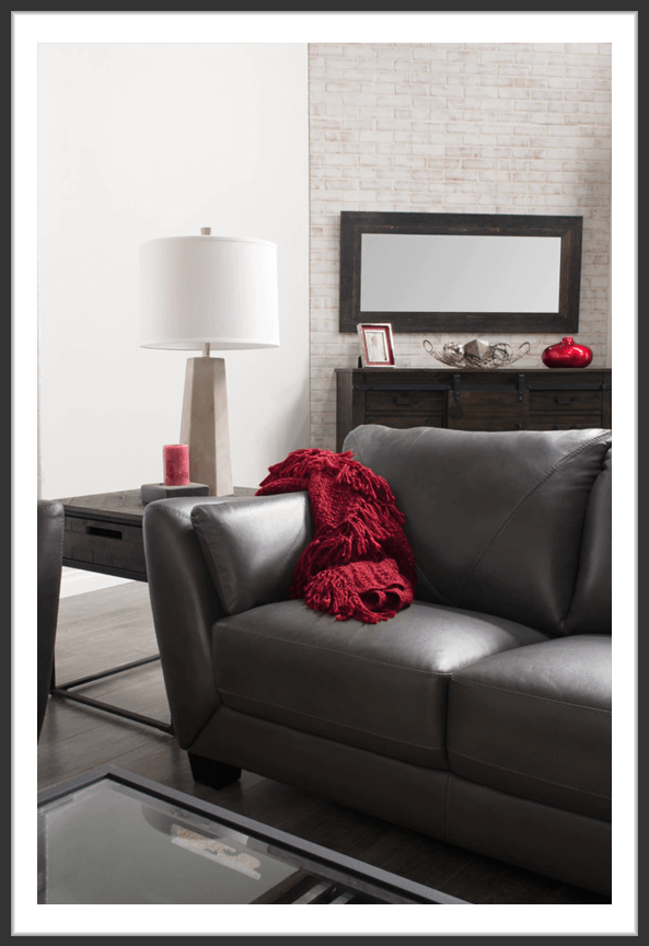 Chateaux d’Ax gray leather loveseat in living room