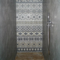 A beautiful bespoke monochrome encaustic tile patchwork design used on shower walls