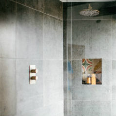 A gorgeous shower room, with our Plain Grey Ghost on the wall, with a cute litte soap dish built in, and tiled with our Pinky Patchwork encaustic tiles
