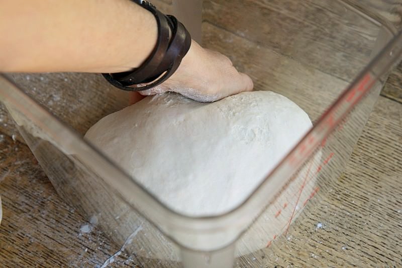 Place dough in a container to rise for bread baked in the Fontana wood-fired oven